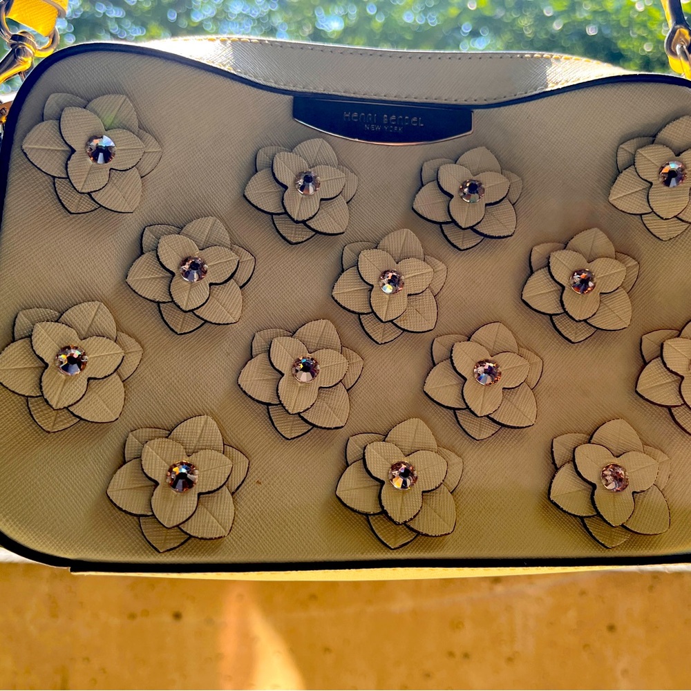 Henri Bendel cream yellow handbag w rhinstones and leather floral applique.